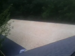 New OSB roof sheathing installed beside an existing shingle roof in Church Hill