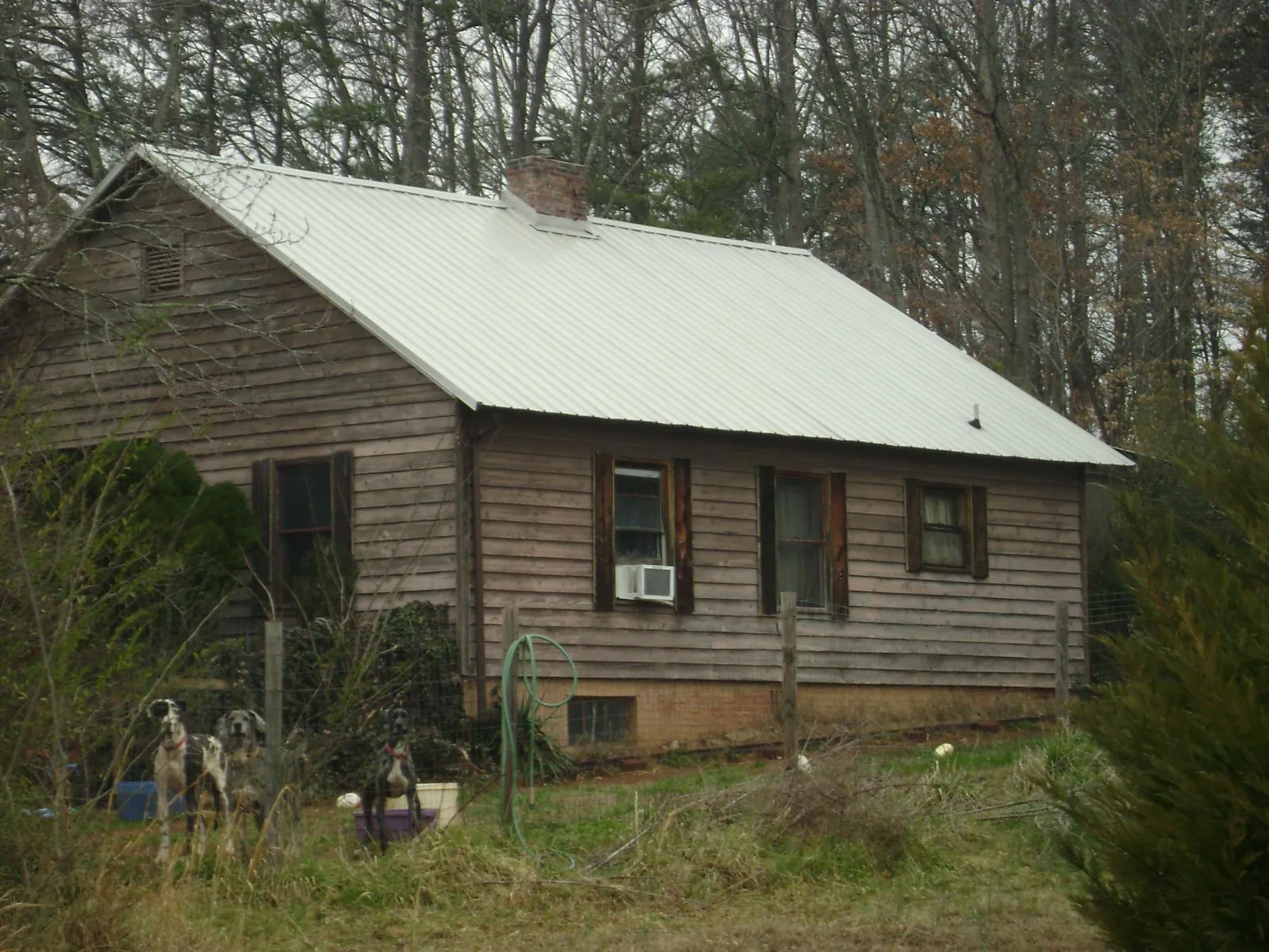 White metal roof on an old wood sided farmhouse, from a Metal Roof Installation job in Church Hill